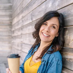 miling local business owner standing in front of their clean restaurant after a professional commercial pest management service.