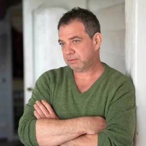 Smiling homeowner standing in a clean backyard after a successful rat exclusion and rodent proofing service by Bye Bye Bugs LA